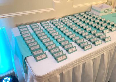 A grouping of 80 guest invite name tags on a table