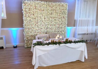 The sweetheart table for Danielle & Michael with flower wall behind