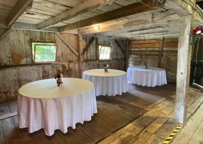 Inlet cove inside rustic barn consisting of three tables