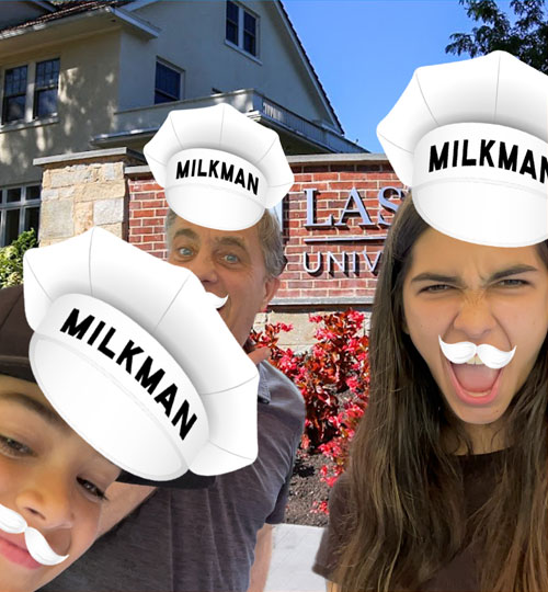 Fun Photo Booth image that includes a group of people wearing milkman hats and mustaches