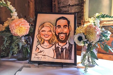 Caricature drawing of wedding couple on a table with flowers
